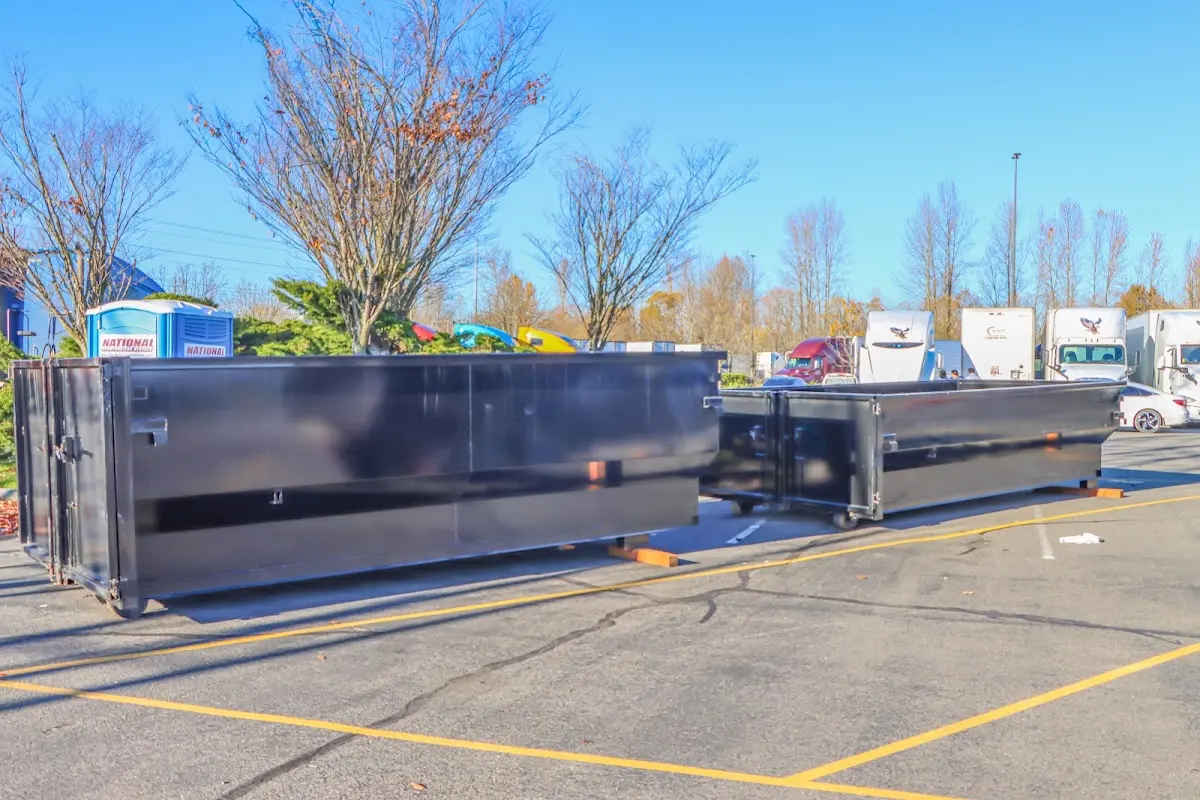 Professional dumpster rental service with roll-off container on residential driveway in Lorton